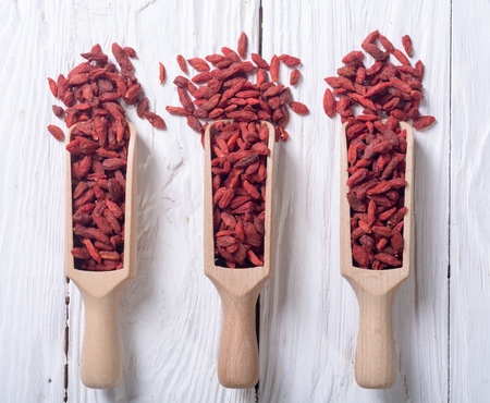 Goji berries in wooden spoon . Superfood backgroundの写真素材