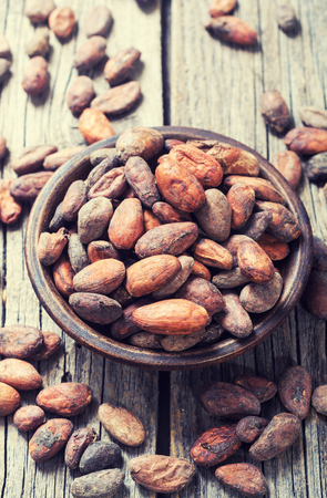 Cocoa beans in bowl . Ingredient for chocolate .の写真素材