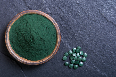 Green spirulina powder in bowl and pills . nature medicineの写真素材