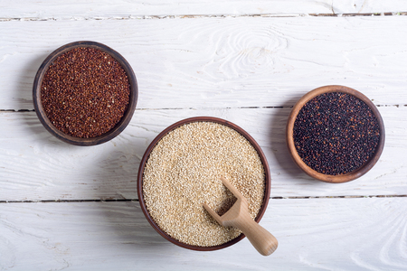 Black , white and red quinoa in bowl on wooden background . Superfood の写真素材