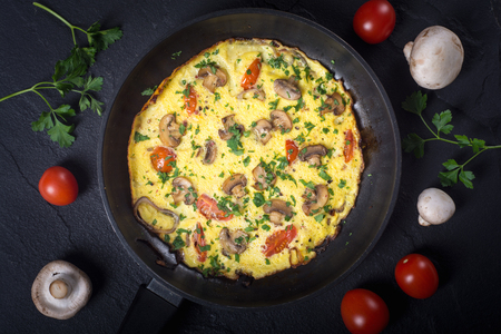 Omelette with mushroom , tomatoes and parsley . Food backgroundの写真素材