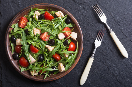 Salad with arugula , tomatoes , olives and chickenの写真素材