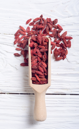 Goji berries in wooden spoon . Superfood backgroundの写真素材