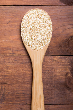 White quinoa in spoon on wooden background . Superfood の写真素材