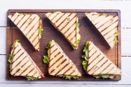Club sandwich with tomatoes , cucumber , ham , cheese and salad . Clubsandwichの写真素材