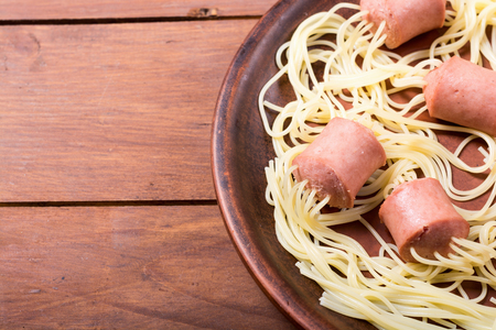 Pasta spaghetti with sausage on rustic backgroundの写真素材
