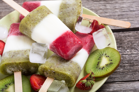 Colorful ice cream with strawberry , yogurt and kiwi . Summer dessertの写真素材