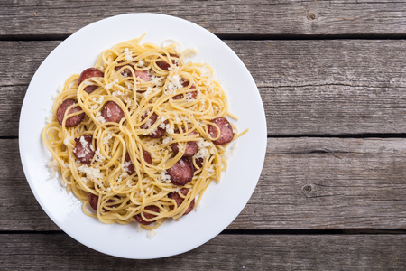 Pasta spaghetti with sausages and cheese parmesan . Italian foodの写真素材