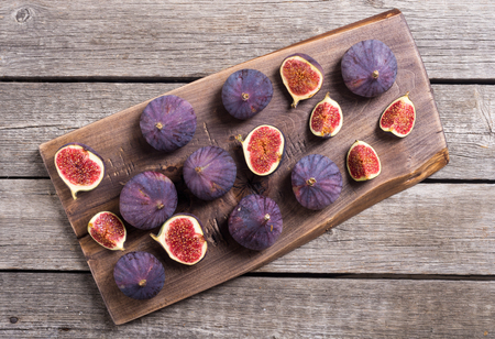 Fresh autumn fruit figs . Healthy food on rustic background