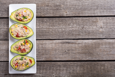 Avocado stuffed with salad from vegetables , parsley and eggsの写真素材