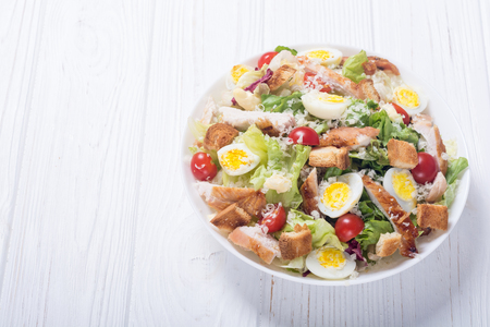 Salad ceasar with chicken , eggs , tomatoes and croutonsの写真素材
