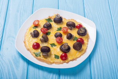 Omelette with mushroom , tomato and parsley . Frittataの写真素材