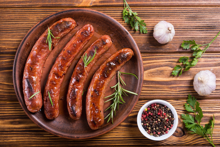 Grilled sauusages on a plate . Unhealthy food background . Barbecueの写真素材