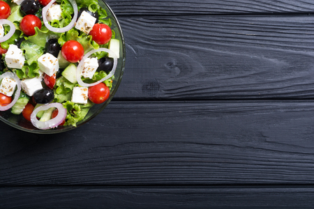 Fresh vegetables greek salad . Healthy food on wooden backgroundの写真素材