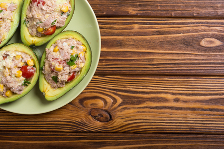 Avocado stuffed with salad from vegetables , parsley and eggsの写真素材