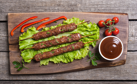 Caucasian traditional food . Shish kebab or lula-kebab with vegetables and sauceの写真素材