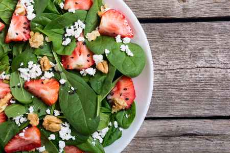 Strawberry salad with spinach , cheese and walnut . Healthy foodの写真素材