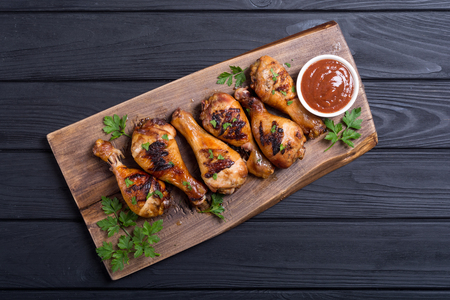 Grilled chicken legs with tomato sauce . BBQ food backgroundの写真素材