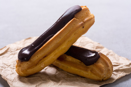 French dessert eclair with chocolate . Delicious food background