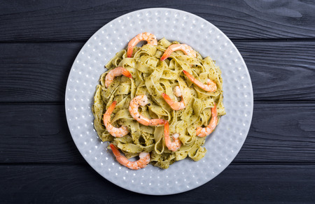Pasta tagliatelle with sauce pesto and shrimps . Italian food backgroundの写真素材