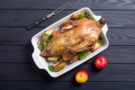 Homemade baked duck with potatoes and apple . Christmas foodの写真素材