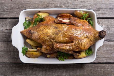 Homemade baked duck with potatoes and apple . Christmas foodの写真素材