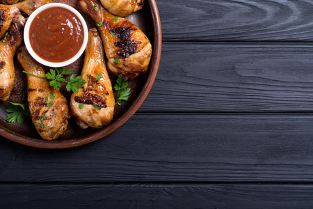Grilled chicken legs with tomato sauce BBQ food backgroundの写真素材