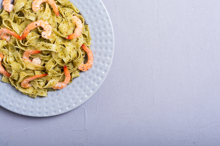 Pasta tagliatelle with sauce pesto and shrimps . Italian food backgroundの写真素材
