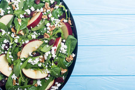 Autumn spinach salad with apple , cheese , walnut and dried cranberry . Healthy vegetarian foodの写真素材