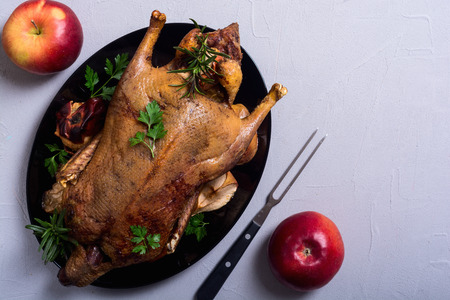 Roast baked duck . Christmas food on wooden backgroundの写真素材