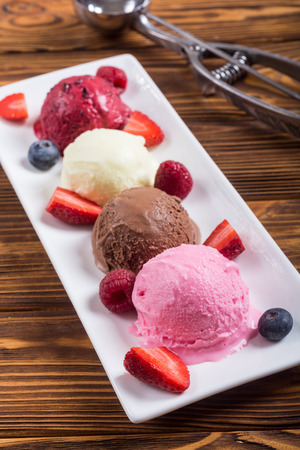 Mix of ice cream ball . berries , chocolate and vanillaの写真素材