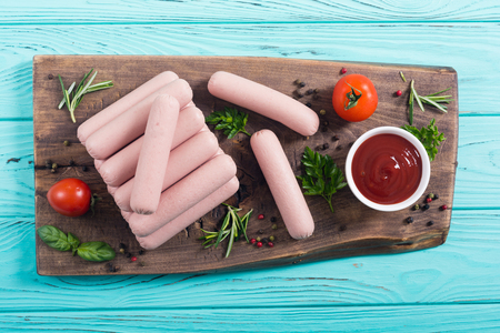 Raw beef sausages with pepper , herbs and ketchup . Food backgroundの写真素材