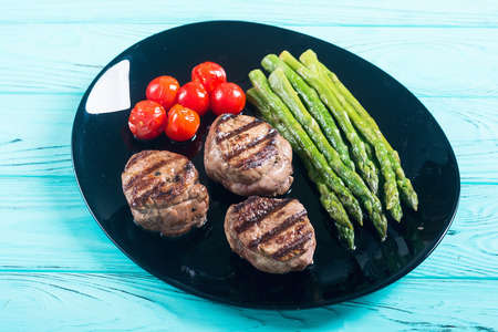 Grilled filet mignon with asparagus and tomatoes . Beef sreak on rustic backgroundの写真素材