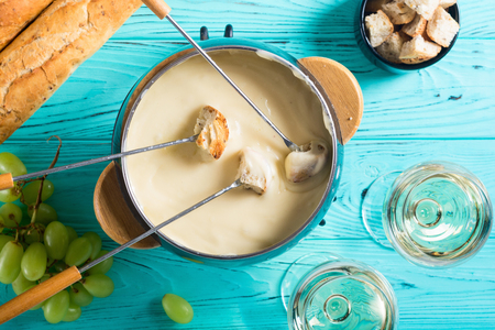 Cheese fondue with bread wine and grape . Swiss winter foodの写真素材