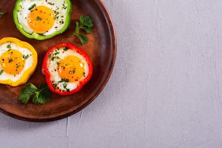 Yellow , red and green pepper with fried eggs . Colorful healthy breakfastの写真素材