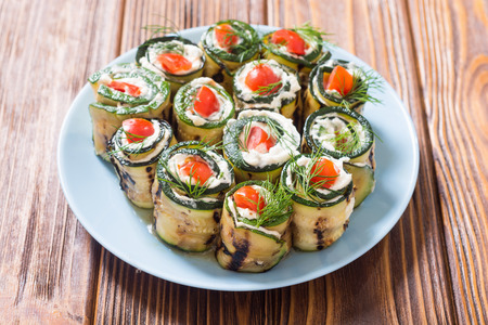 Zucchini rolls with cream cheese , tomatoes and dill . Healthy vegetarian food backgroundの写真素材