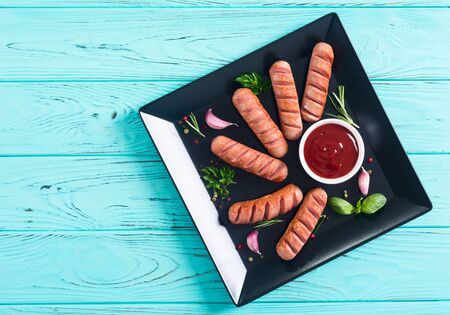 Fried sausages with herbs , spices and ketchup . Food backgroundの写真素材