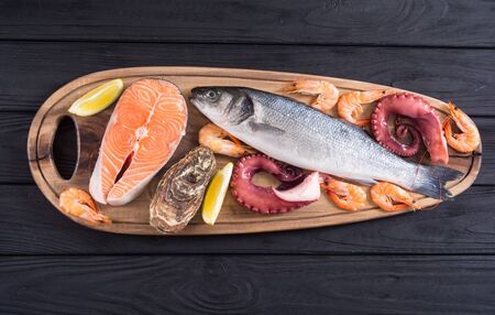 Seafood background . Salmon , sea ââbass , oysters and octopusの写真素材