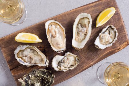Fresh Oysters with lemon and white wine  . Seafood backgroundの写真素材