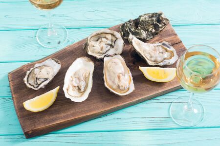 Fresh Oysters with lemon and white wine  . Seafood backgroundの写真素材