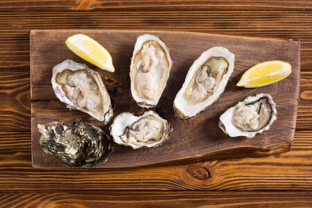 Fresh Oysters with lemon and white wine  . Seafood backgroundの写真素材