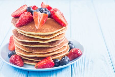 Tasty pancakes with blueberry and strawberry . Breakfast . Food backgroundの写真素材