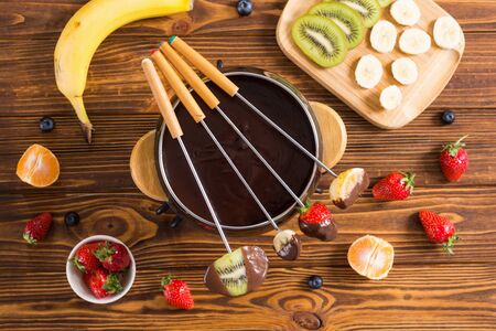 Dessert . Chocolate fondue with fruit and berries . Food backgroundの写真素材