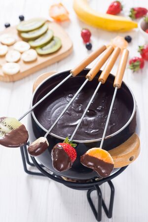 Dessert . Chocolate fondue with fruit and berries . Food backgroundの写真素材