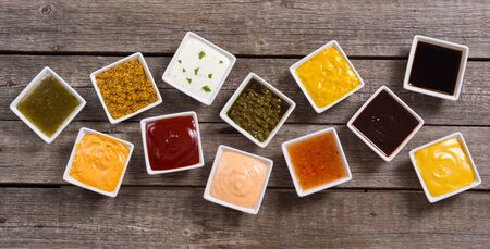 Set of different sauces in ceramic bowl on rustic backgroundの写真素材