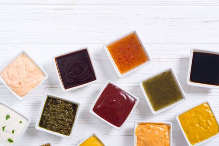 Set of different sauces in ceramic bowl on rustic backgroundの写真素材