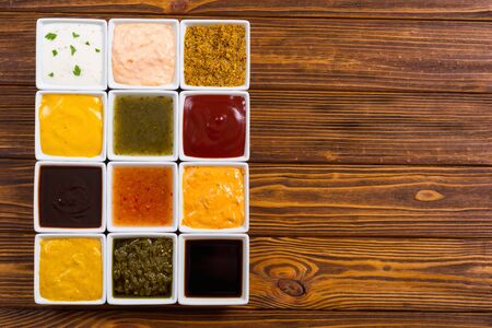 Set of different sauces in ceramic bowl on rustic backgroundの写真素材