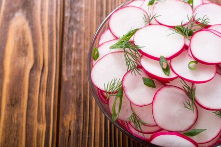 Healthy vegetarian radish salad with green onion and dill .の写真素材