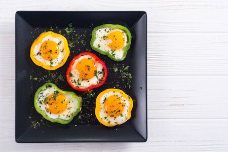 Yellow , red and green pepper with fried eggs . Colorful healthy breakfastの写真素材