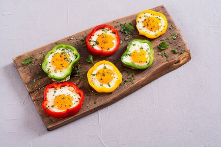 Yellow , red and green pepper with fried eggs . Colorful healthy breakfastの写真素材